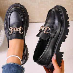 Chunky lug sole loafers in gloss black with gold chain detail.