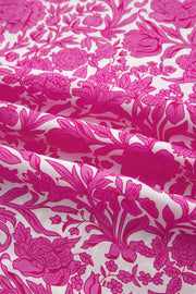 Vibrant floral print midi dress with ruffle sleeves in pink and white.