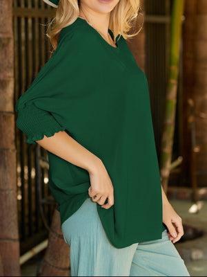 Dark green textured blouse with elastic cuff sleeves and crew neck.