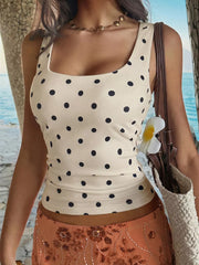 Chic polka dot tank top with scoop neck in apricot, fitted cropped style.