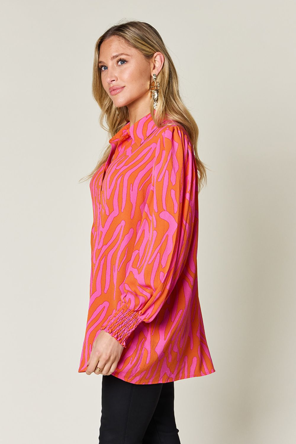 Orange and pink zebra print blouse with shirred cuffs and a collared neckline.