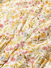 Floral print button-down shirt dress with pink and yellow flowers on a white background.