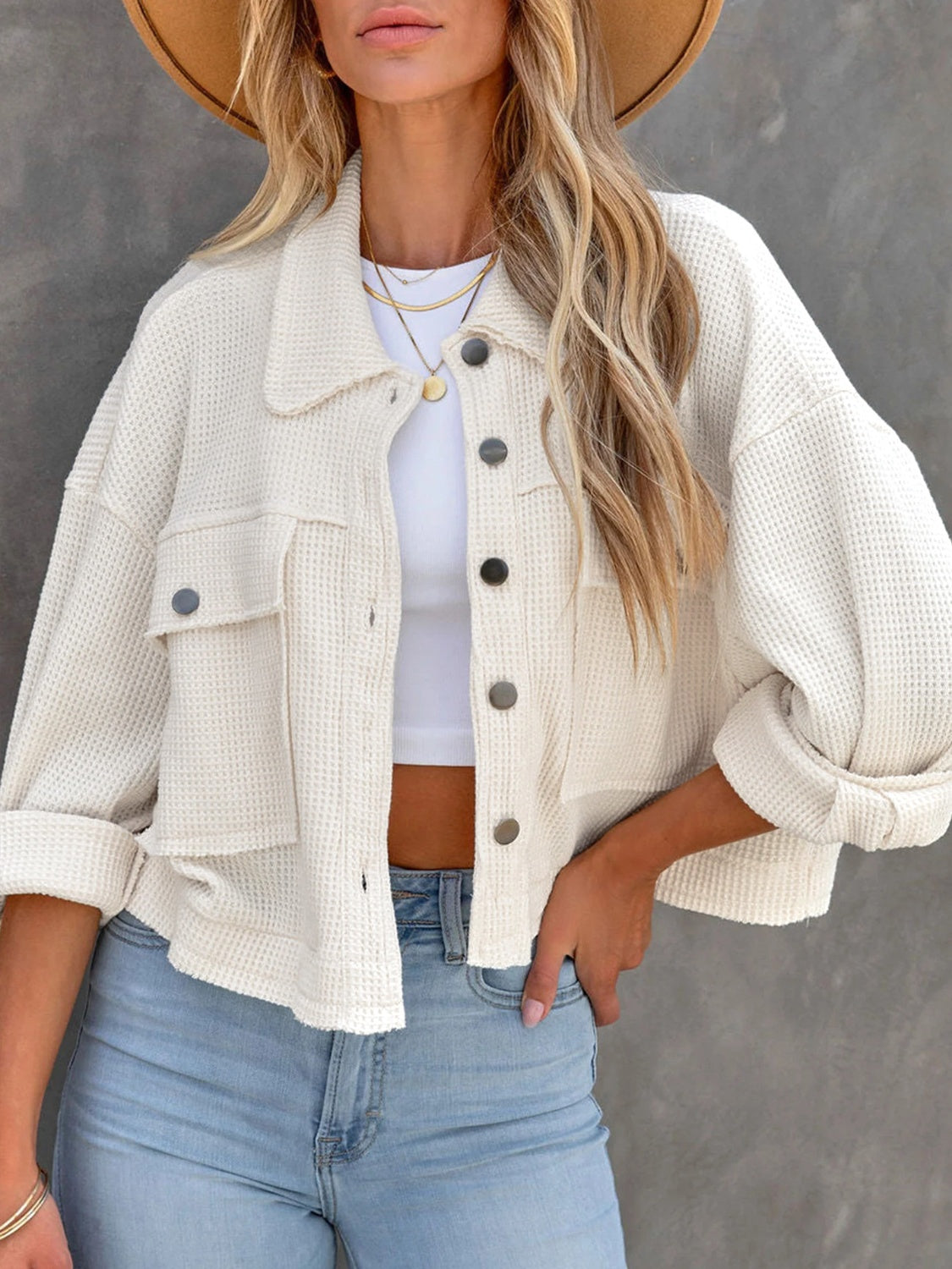 White waffle knit cropped utility jacket with button front and chest pockets.
