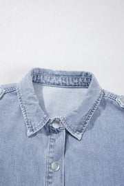 Light blue denim shirt jacket with button front and collar detail.