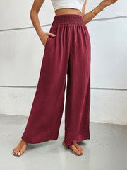 Burgundy textured palazzo lounge trousers with smocked waist and pockets.