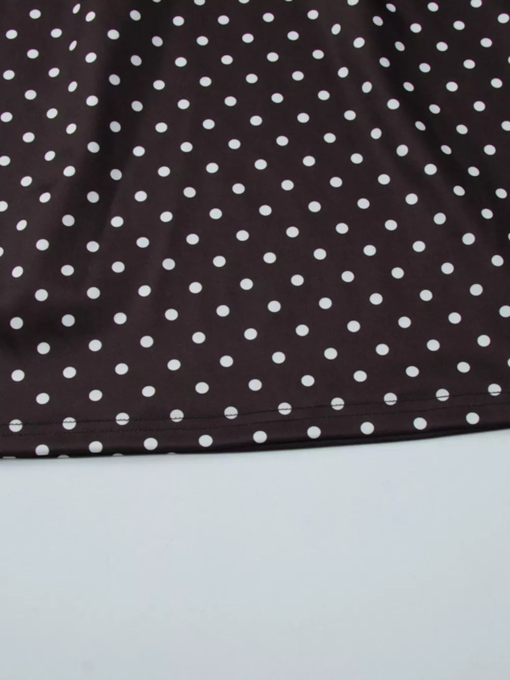Brown polka dot mini dress with a cut-out detail