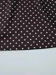 Brown polka dot mini dress with a cut-out detail