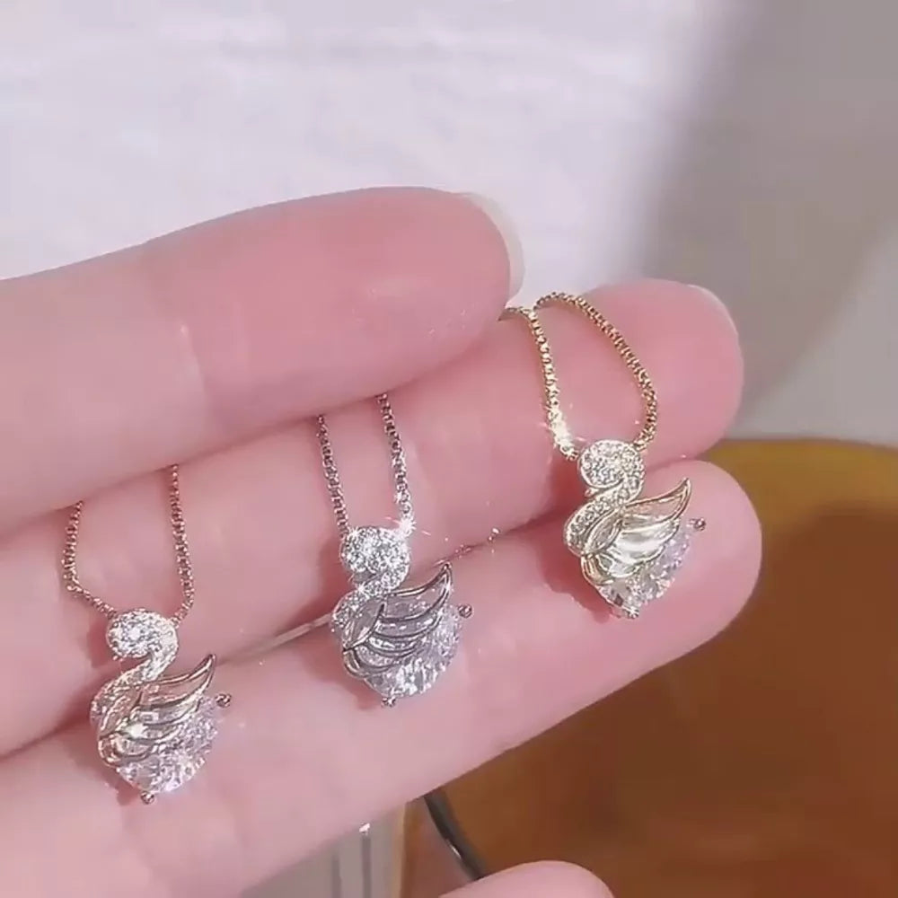 Swan pendant necklaces in gold, silver, and rose gold, featuring cubic zirconia and 925 sterling silver.