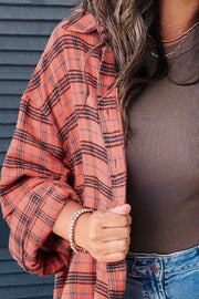 Oversized orange-red plaid shacket with a collar and patch pocket detail.