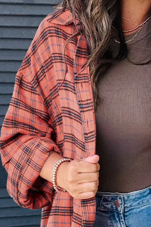 Oversized orange-red plaid shacket with a collar and patch pocket detail.