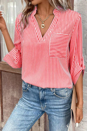 Red and white striped V-neck blouse with a chest pocket and rolled tab sleeves.