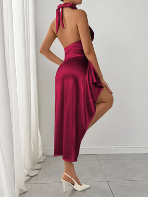 Burgundy satin halter dress with a thigh-high slit and flowing skirt.