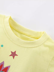 Yellow cotton blend t-shirt with unicorn graphic, stars, and polka dots.