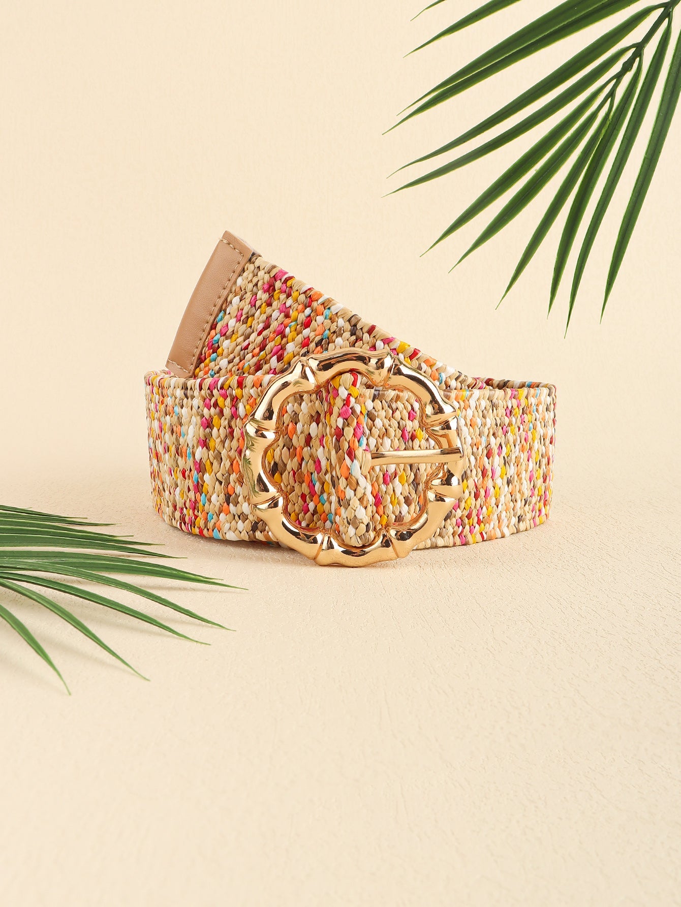 Woven raffia belt in multicolor with a sculpted gold buckle and tan leather trim.