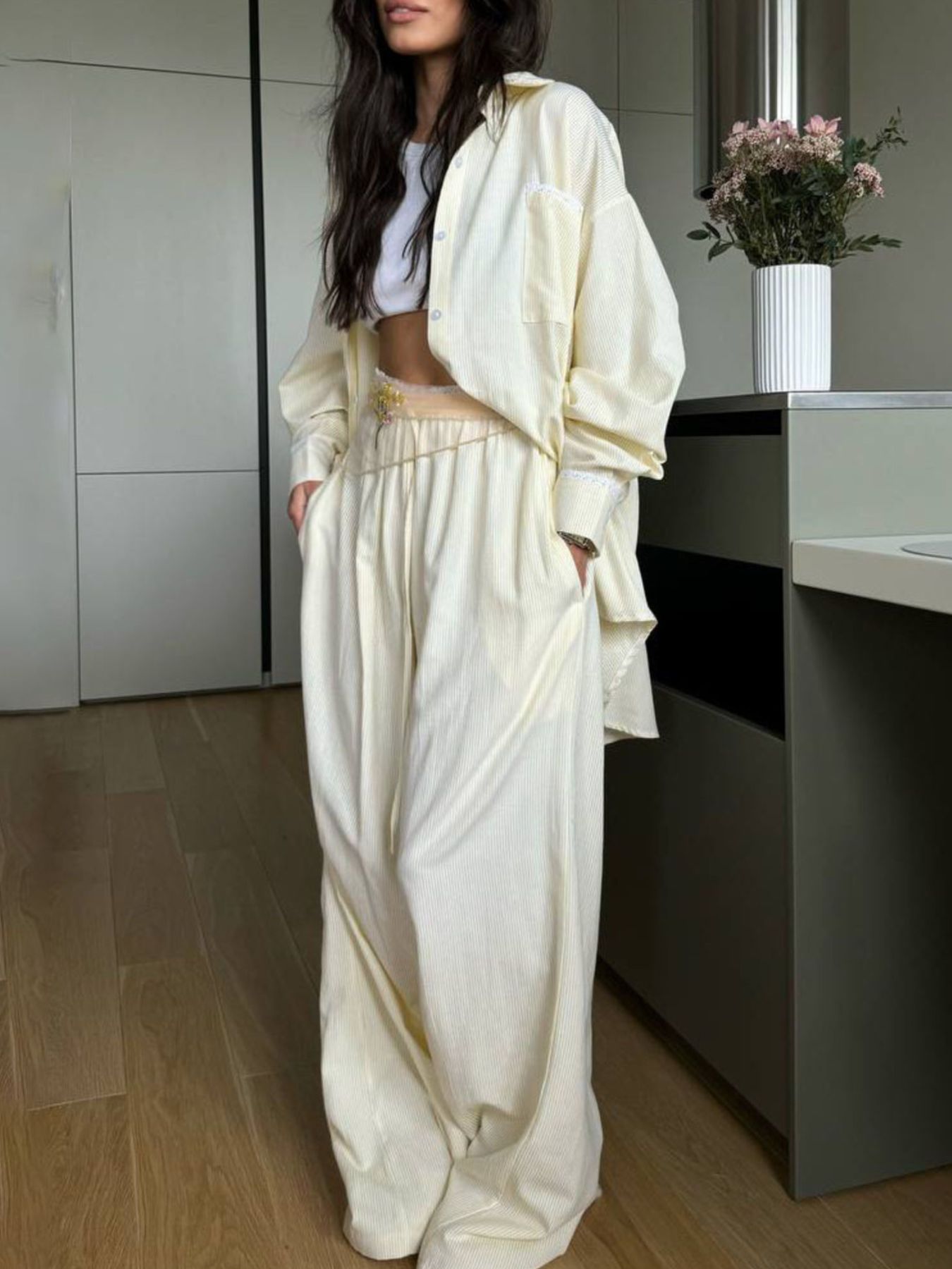 Pinstriped pastel yellow pajama set with button-down shirt and drawstring pants.