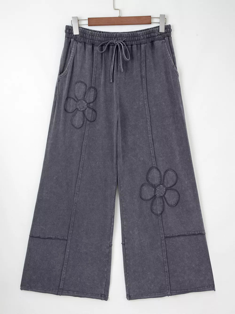 Maternity cropped wide-leg pants in charcoal cotton with floral appliqus and drawstring waist.