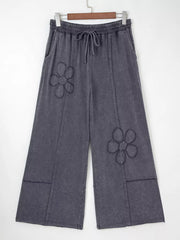 Maternity cropped wide-leg pants in charcoal cotton with floral appliqus and drawstring waist.
