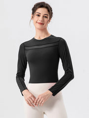 Black long sleeve crop top with mesh panel detail at neckline and sleeves.