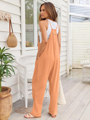 Tangerine relaxed fit overalls jumpsuit with zipper detail and pockets, worn with a white tank top.