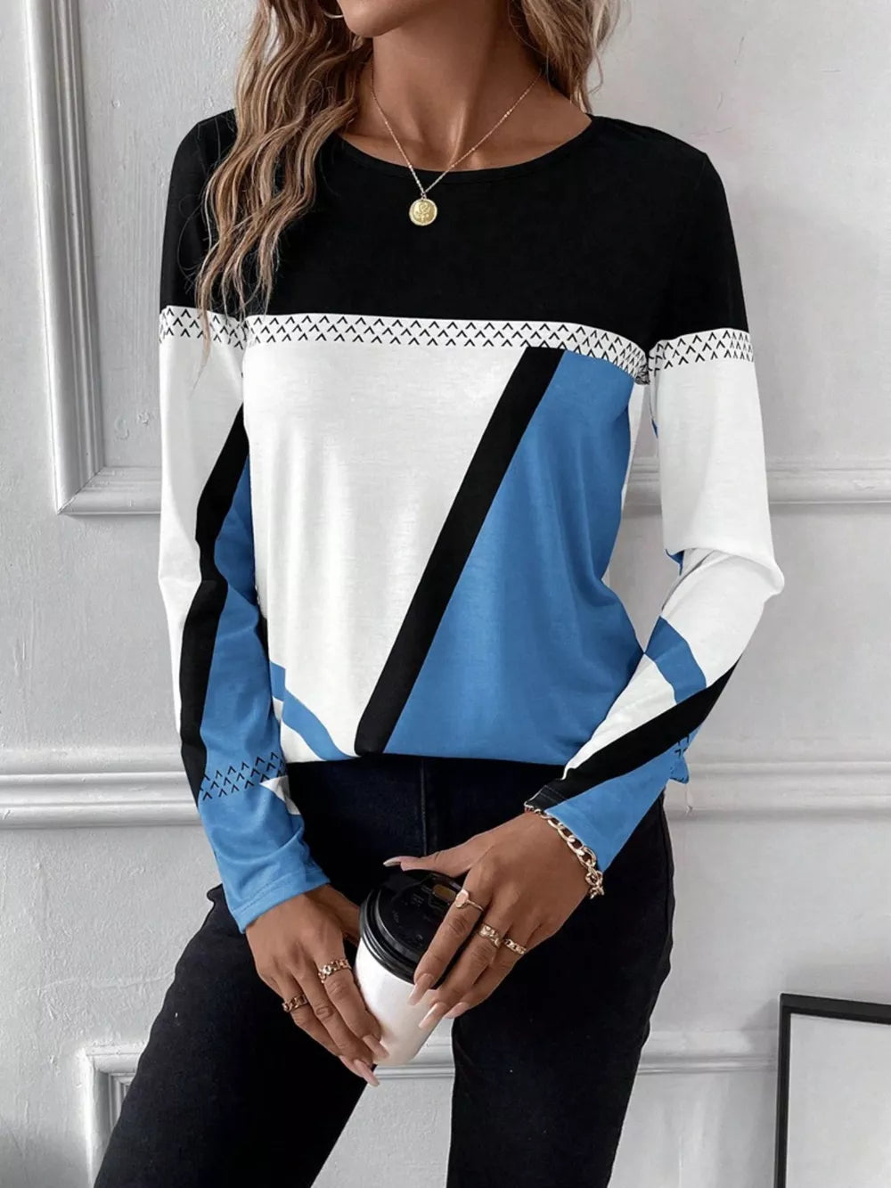Geometric panel long sleeve t-shirt in black, white, and sky blue with chevron detail.