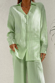 Pleated pastel blue co-ord set with button-down shirt and wide leg trousers.