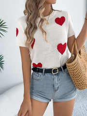 White knit t-shirt sweater with red heart pattern and short sleeves.
