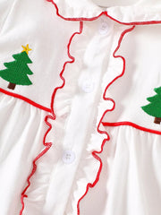 White baby dress with embroidered Christmas trees, red ruffled trim, and buttons.