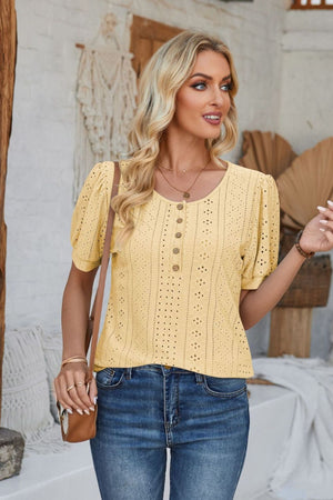 Light yellow perforated puff sleeve henley blouse with button detail and round neckline.