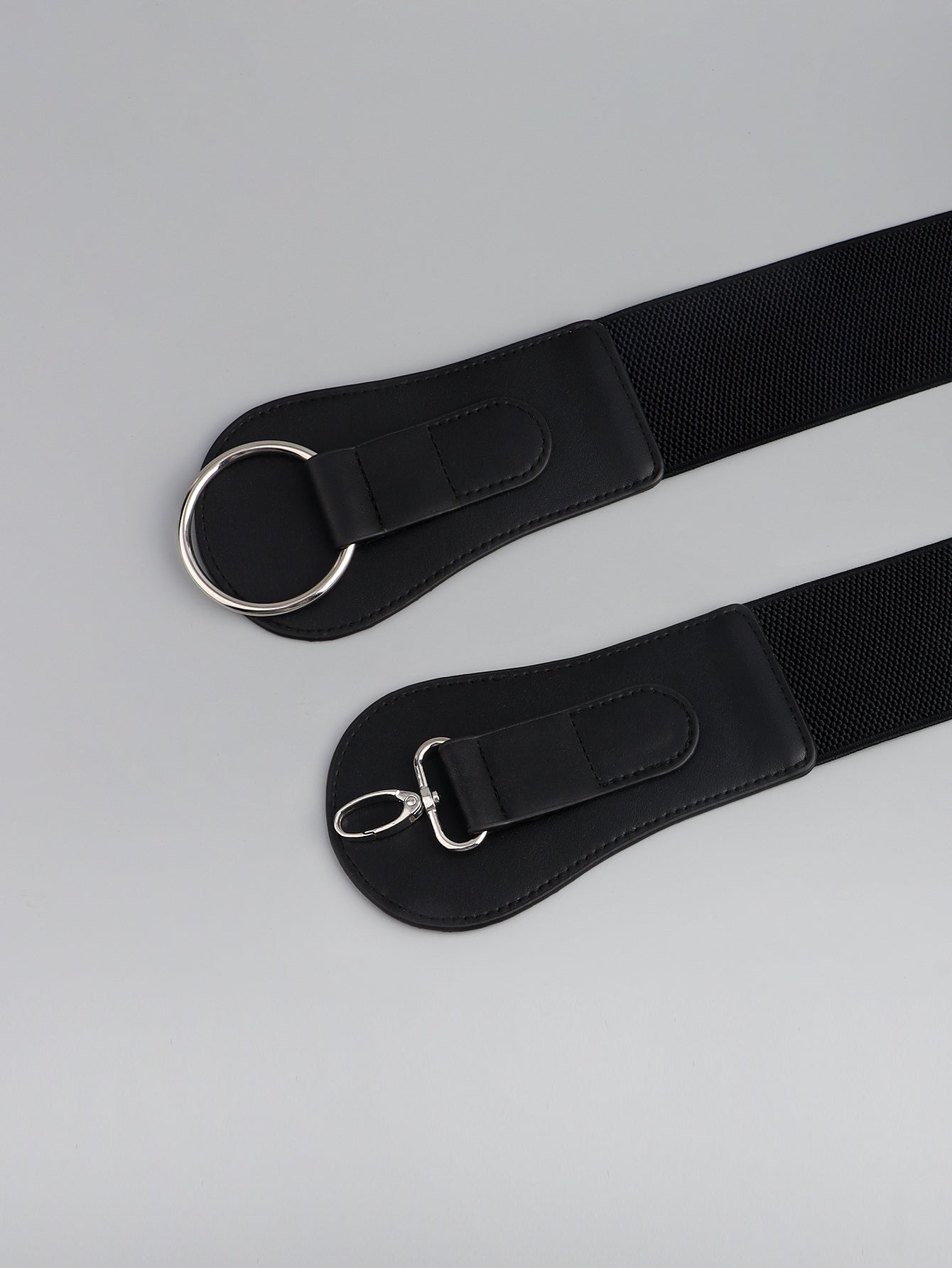 Black elastic cincher belt with silver buckle and clasp detail