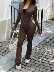 Brown zippered activewear set with thumbhole sleeves and flared pants.