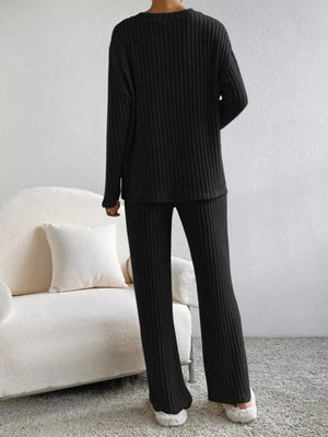 Black ribbed knit loungewear set with long sleeves and flared pants.