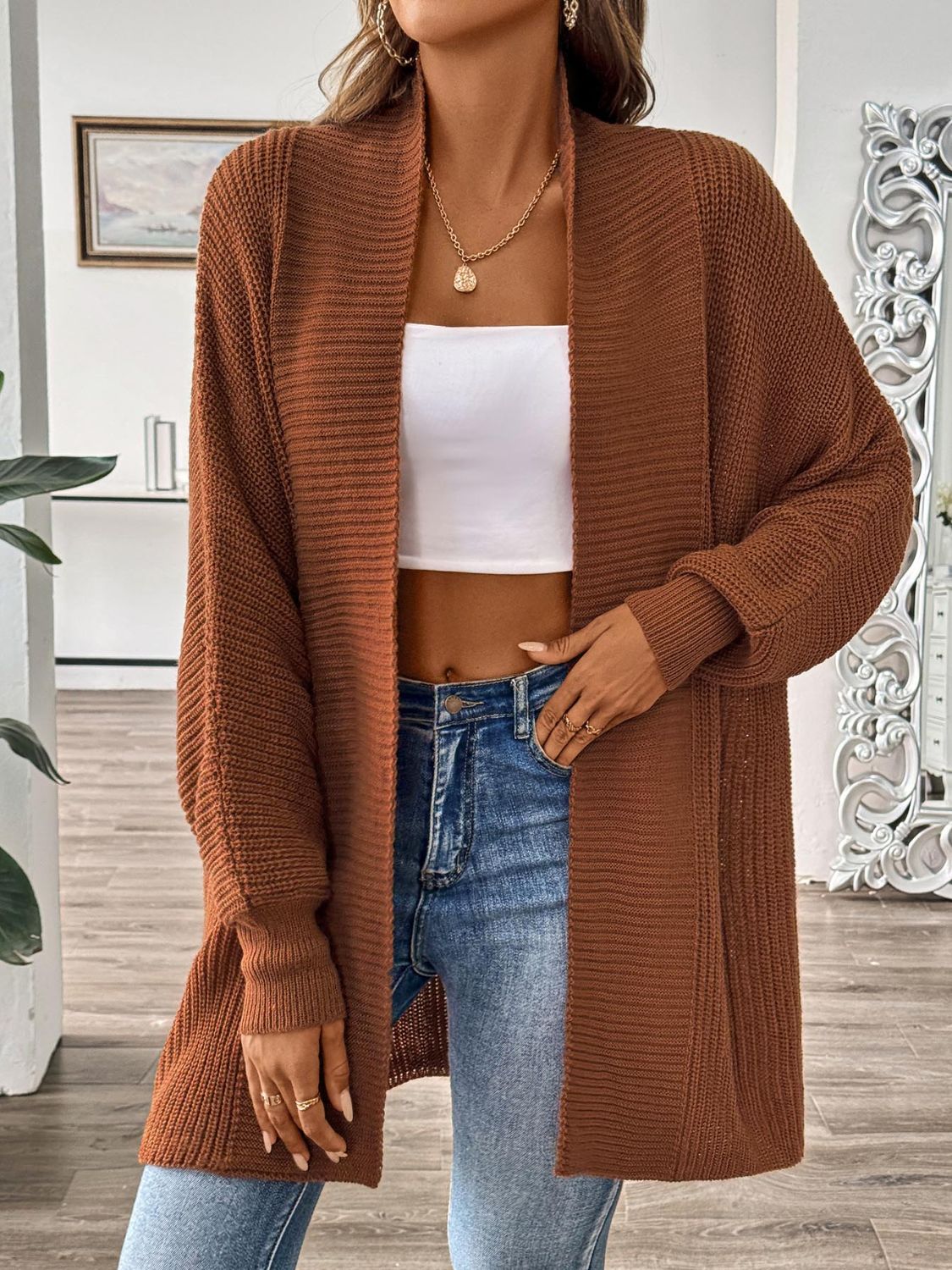 Brown ribbed knit cocoon cardigan with open front and long sleeves.
