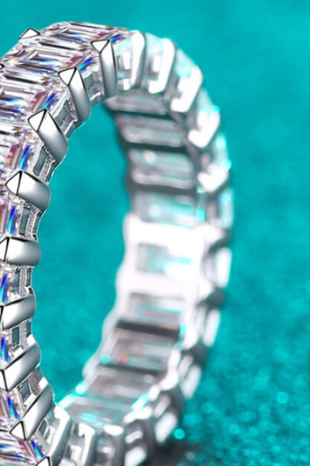 Silver eternity band with emerald cut stones and prong setting