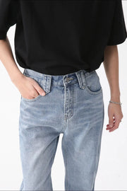 Wide-leg denim jeans in medium wash with carpenter pockets.