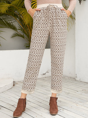 Geometric print drawstring trousers with cuffed hems and pockets.