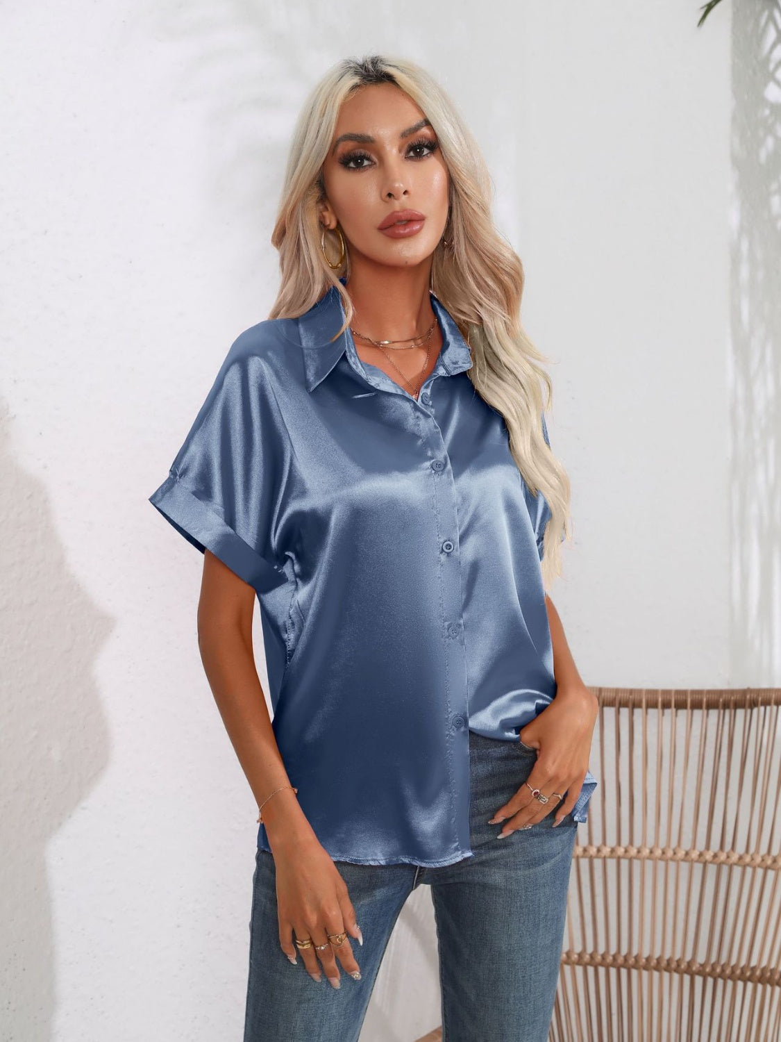 Dusty blue satin boxy sleeve blouse with button-down front and collar.