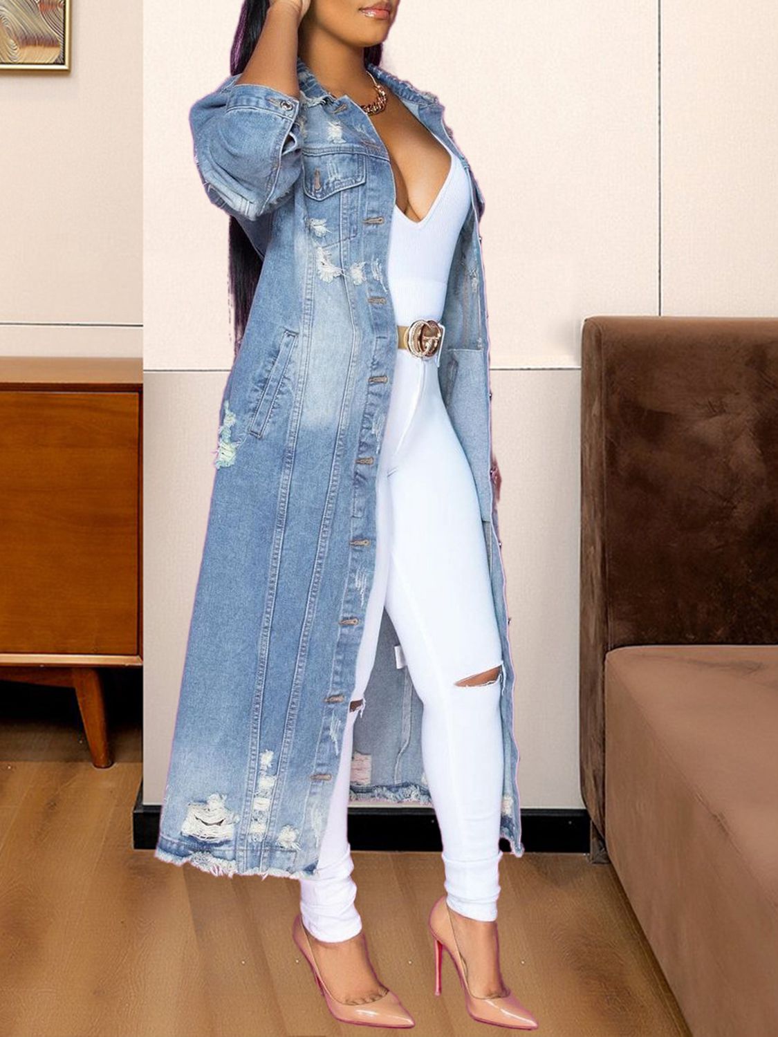 Distressed light wash denim duster coat with a longline cut and frayed hem.