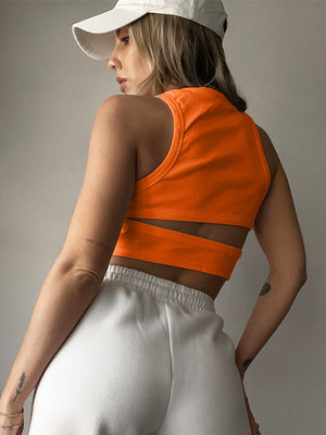 Orange ribbed crop top with cutout detail and high neckline.