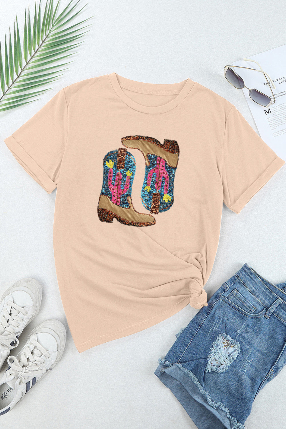 Eggshell cotton t-shirt with a graphic of sequined cowboy boots with cacti.