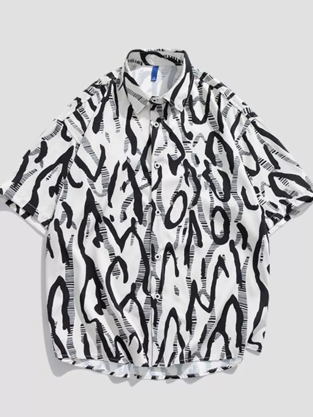 Oversized white cotton button-up shirt with black abstract graphic print.