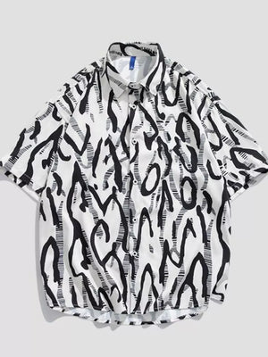 Oversized white cotton button-up shirt with black abstract graphic print.