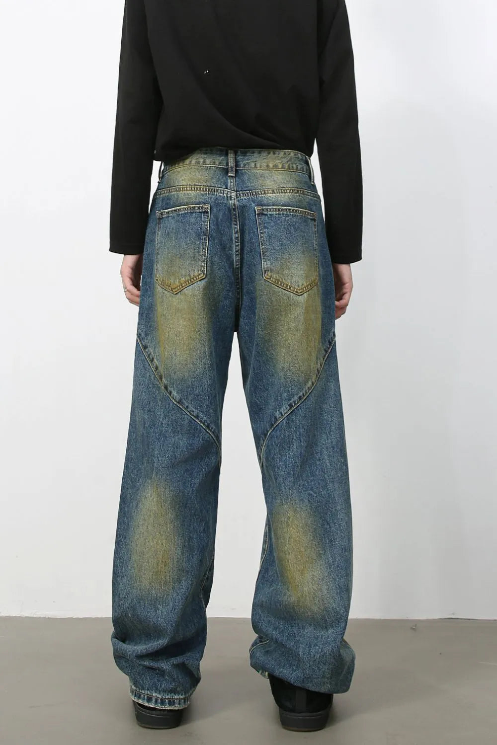 Panelled denim jeans in medium acid wash with a wide leg cut and distressed details.