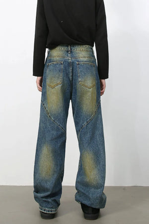 Panelled denim jeans in medium acid wash with a wide leg cut and distressed details.