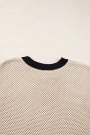 Beige knit top with black contrast trim neckline and cap sleeves.