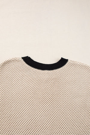 Beige knit top with black contrast trim neckline and cap sleeves.