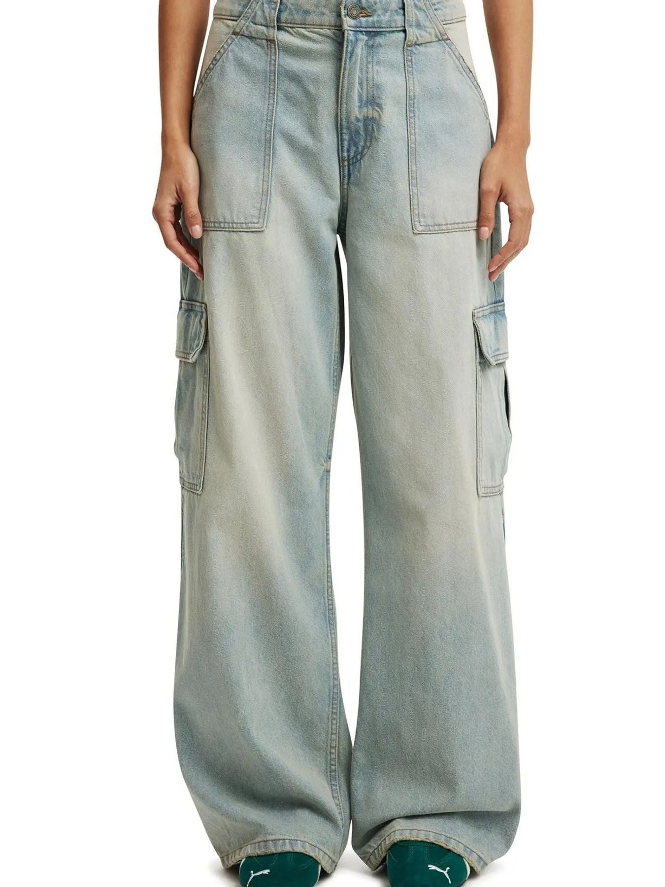 Wide leg cargo denim jeans in light blue with multiple pockets and a relaxed fit.