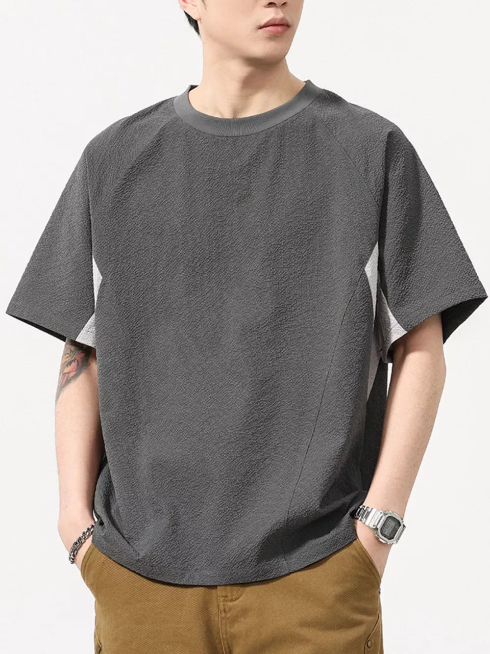 Men's dark gray textured t-shirt with contrast panels and crew neck.