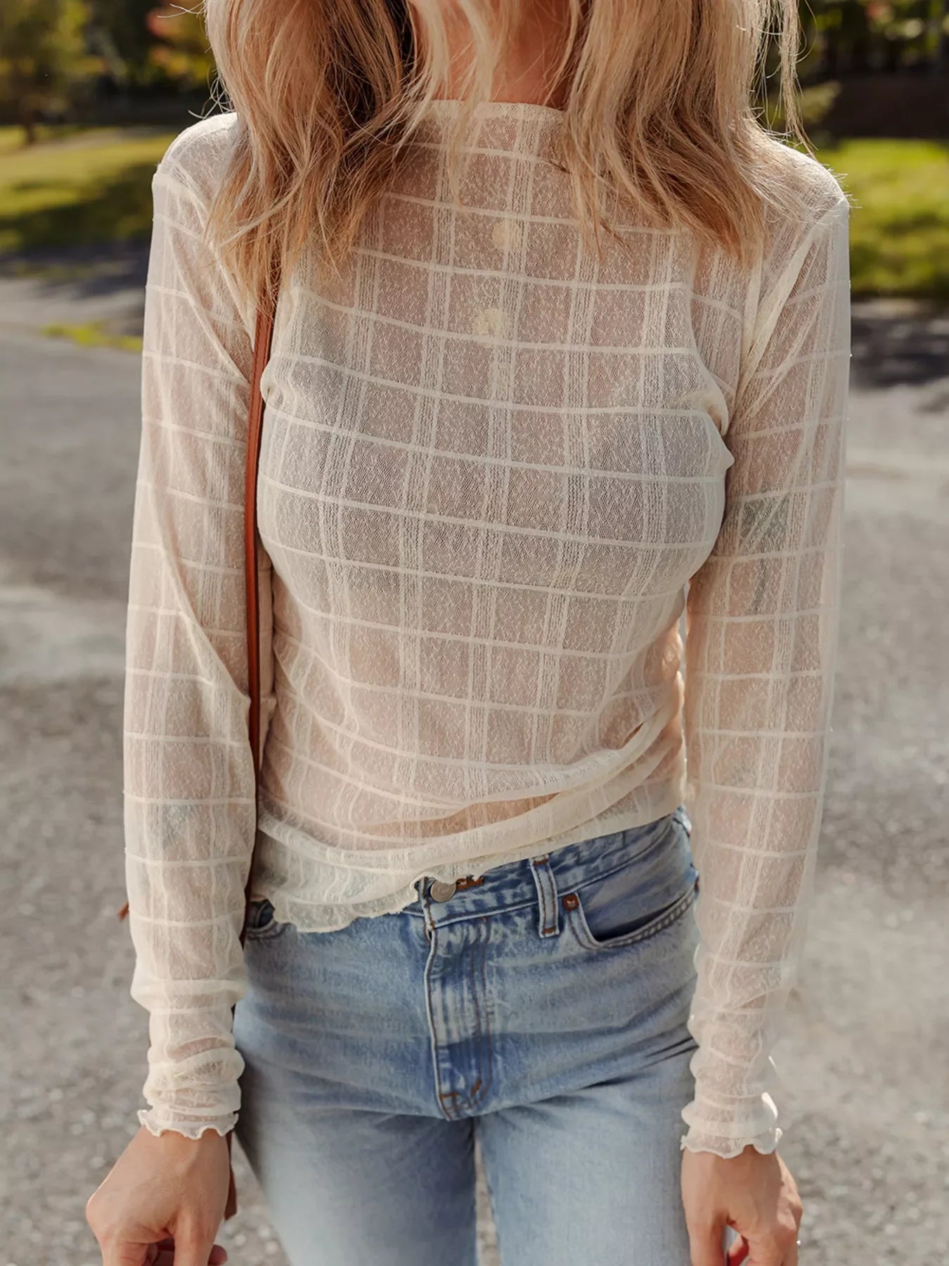 Sheer beige long-sleeve top with a plaid pattern and lettuce trim cuffs.