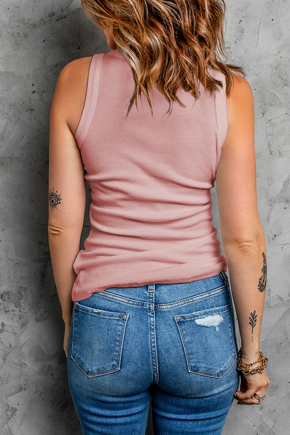 Ribbed knit tank top in dusty pink with scoop neck and racerback detail.
