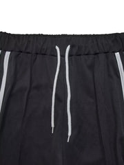 Black wide-leg pants with drawstring and white side stripes